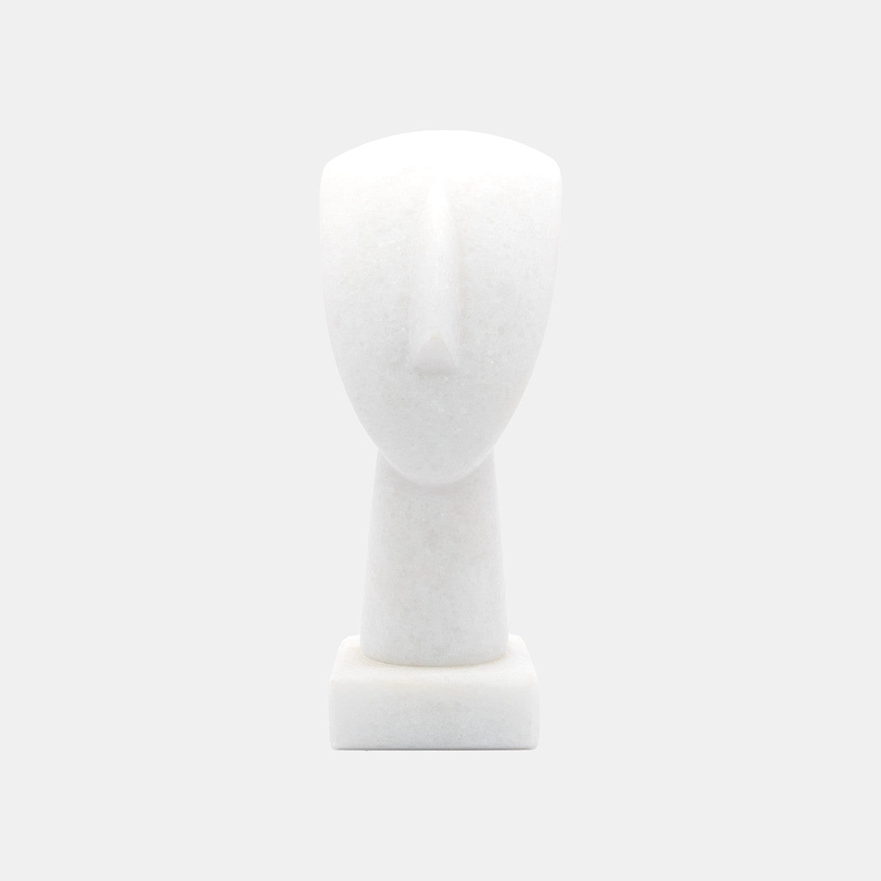 The image shows a simplified representation of a human head and neck on a base, likely a mannequin or a sculptural form. It appears to be made of White Naxos Marble and is designed in a very minimalistic style with few details, emphasising the basic contours of the head and neck. The background is a uniform light colour, providing a neutral backdrop for the object.