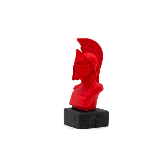 A red handcrafted Leonidas the Spartan clay figurine depicting the ancient Greek warrior king wearing a Spartan helmet.