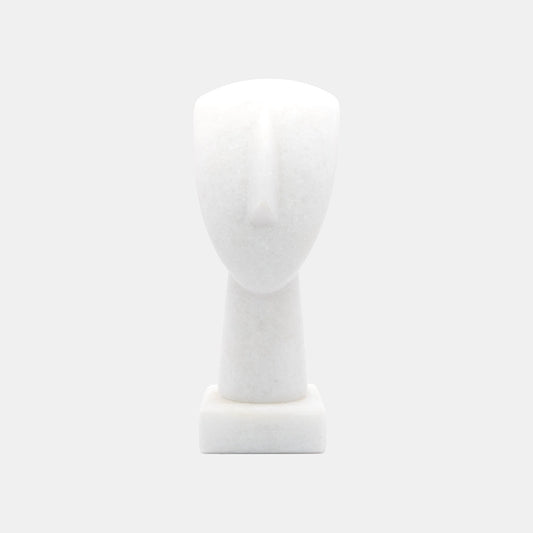 The image shows a simplified representation of a human head and neck on a base, likely a mannequin or a sculptural form. It appears to be made of White Naxos Marble and is designed in a very minimalistic style with few details, emphasising the basic contours of the head and neck. The background is a uniform light colour, providing a neutral backdrop for the object.