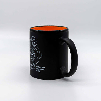 Close up of antikythera mechanism mug in black