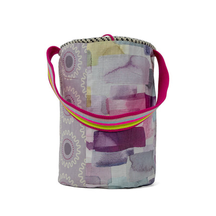 Close up of pop fuchsia handwoven bucket bag in gray