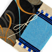 Close up of beige and cycladic blue tassels pouch handcrafted envelope