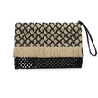 Close up of boho natural straw pouch in black and beige