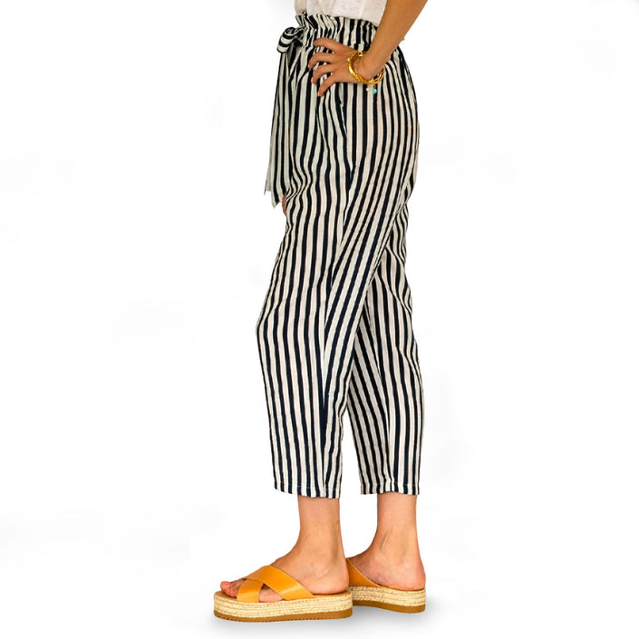 Close up of striped, cropped trousers in navy blue & white