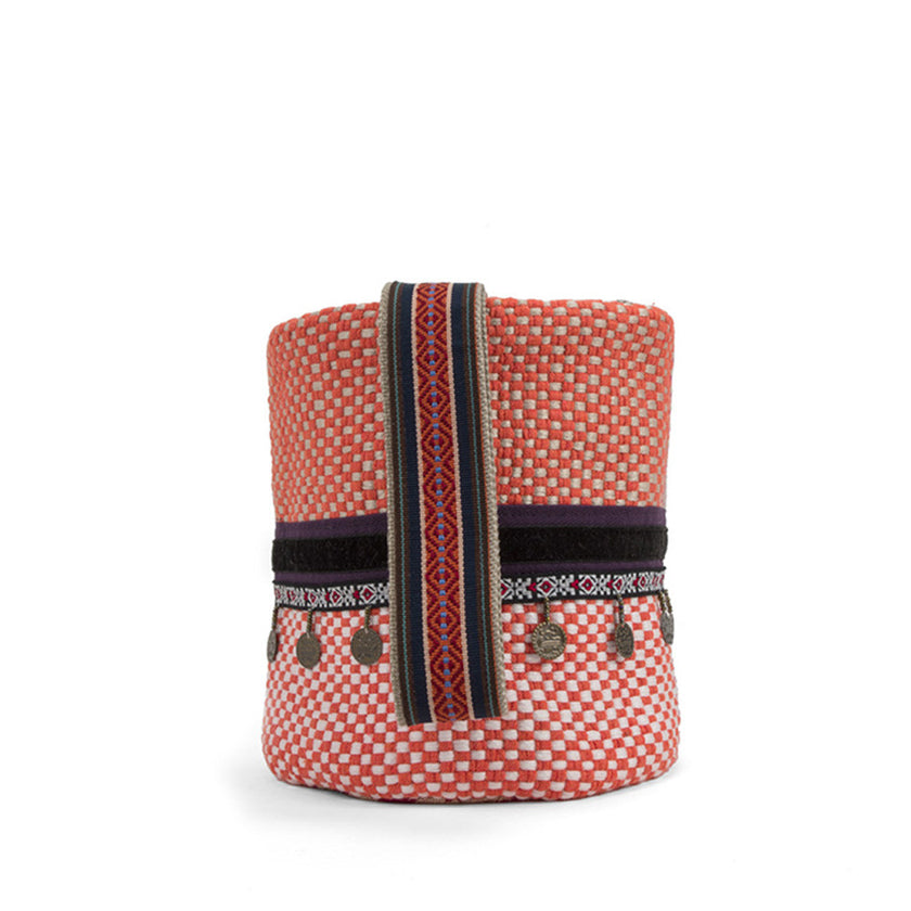 Close up of ethnic wild orchid and orange handwoven bucket bag