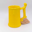 Close up of ceramic beer glass in bright yellow