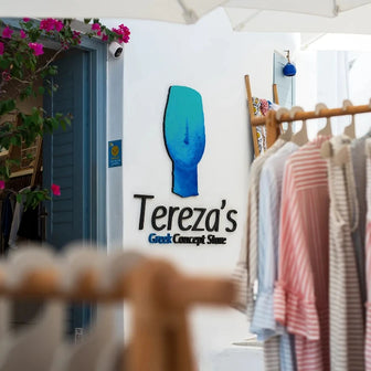Entrance of Tereza’s Greek Concept Store boutique in Naxos Old Town with dresses displayed outside