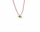 Close up of eye of gold in red, pendant in gold-plated silver