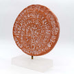 Close up of phaistos disc on a stand, handcrafted art