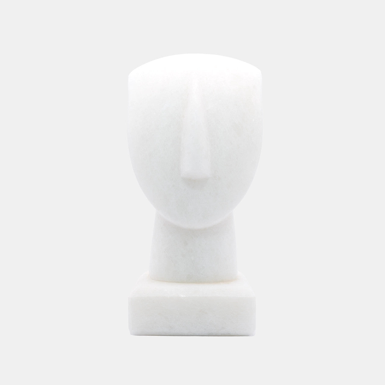 The image shows a simplified representation of a human head and neck on a base, likely a mannequin or a sculptural form. It appears to be made of White Naxos Marble and is designed in a very minimalistic style with few details, emphasising the basic contours of the head and neck. The background is a uniform light colour, providing a neutral backdrop for the object.