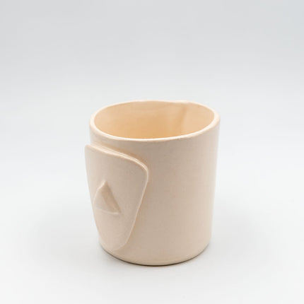 Close up of cycladian style, short ceramic mug in ivory