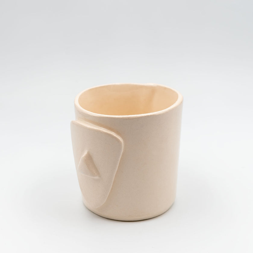 Close up of cycladian style, short ceramic mug in ivory