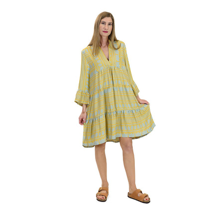 Close up of kaftan dress in champagne yellow & teal