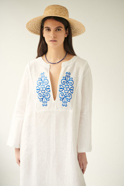 Close up of iris, linen dress in white, embroidered
