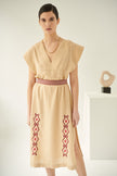 Close up of lysimachia, linen dress in caramel, embroidered