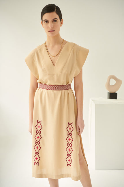 Close up of lysimachia, linen dress in caramel, embroidered