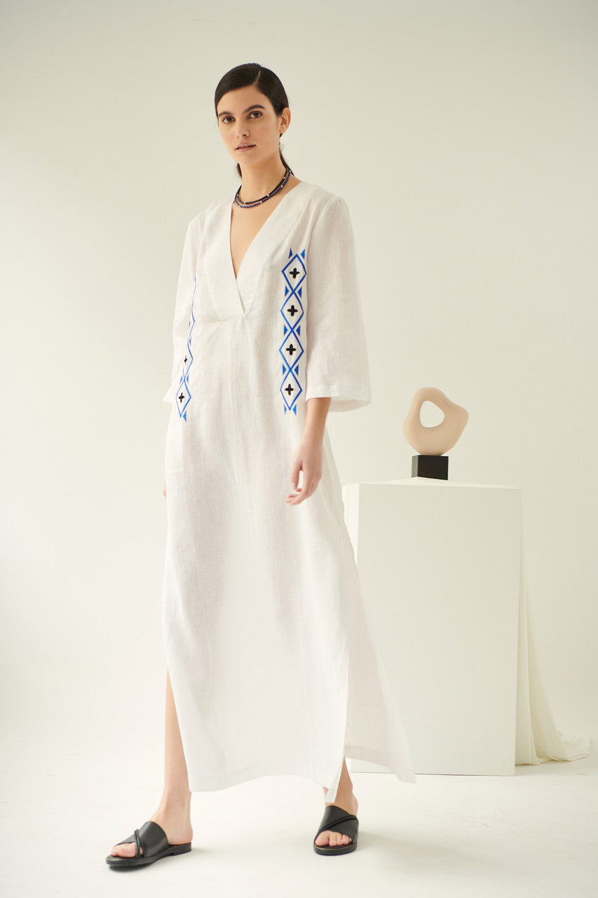 Close up of lobelia, linen dress in white, embroidered