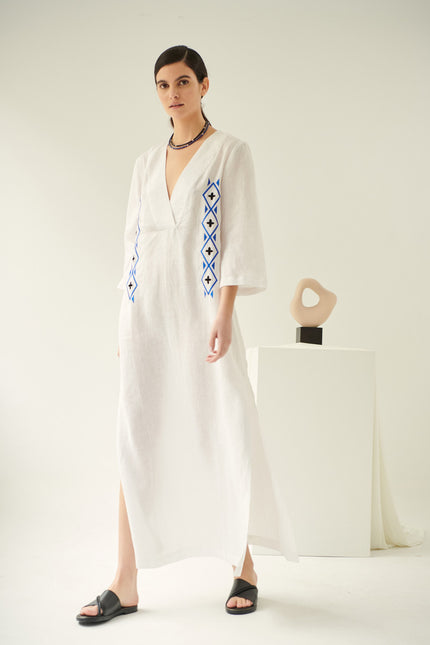 Close up of lobelia, linen dress in white, embroidered