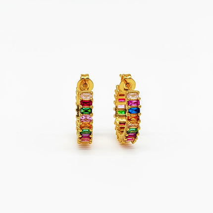 Gold hoop earrings with colorful gemstones on a white background
