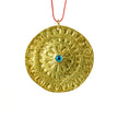 Close up of large round evil eye disc, pendant in gold-plated silver
