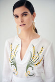 Close up of lillium, linen dress in white, embroidered