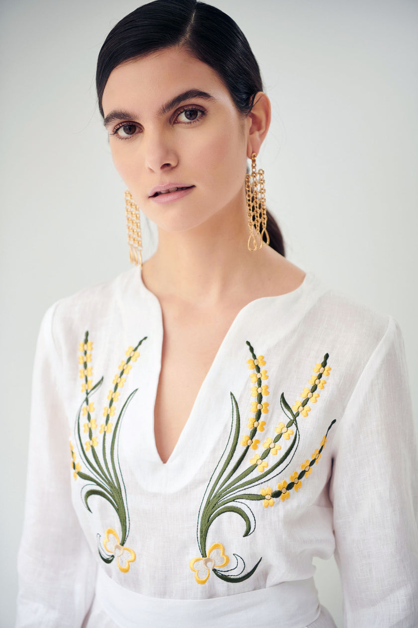 Close up of lillium, linen dress in white, embroidered
