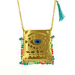 Close up of evil eye tagári, in viridian green, petrol blue and coral red, pendant