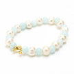 Close up of pearls, baby blue beads & gold dolphin bracelet