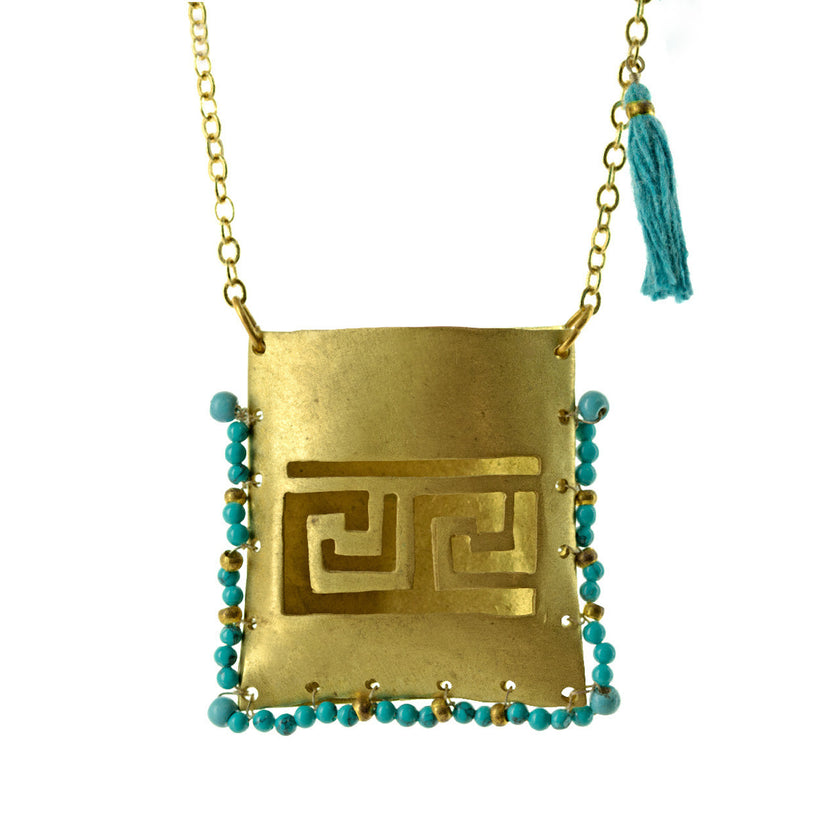 Close up of tagári in petrol green, gold-plated, pendant