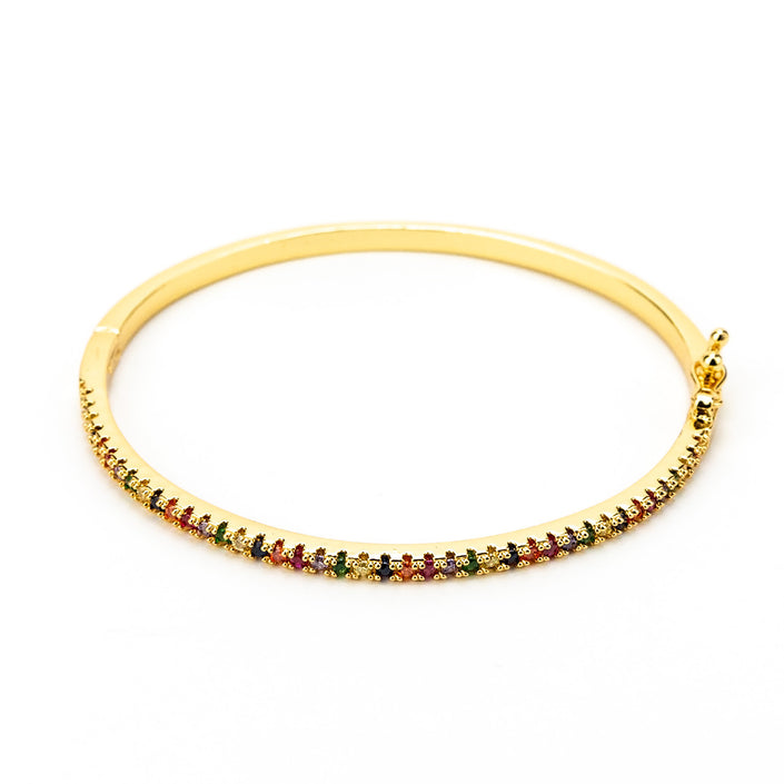 Close up of rainbow zircon, colourful, gold bracelet