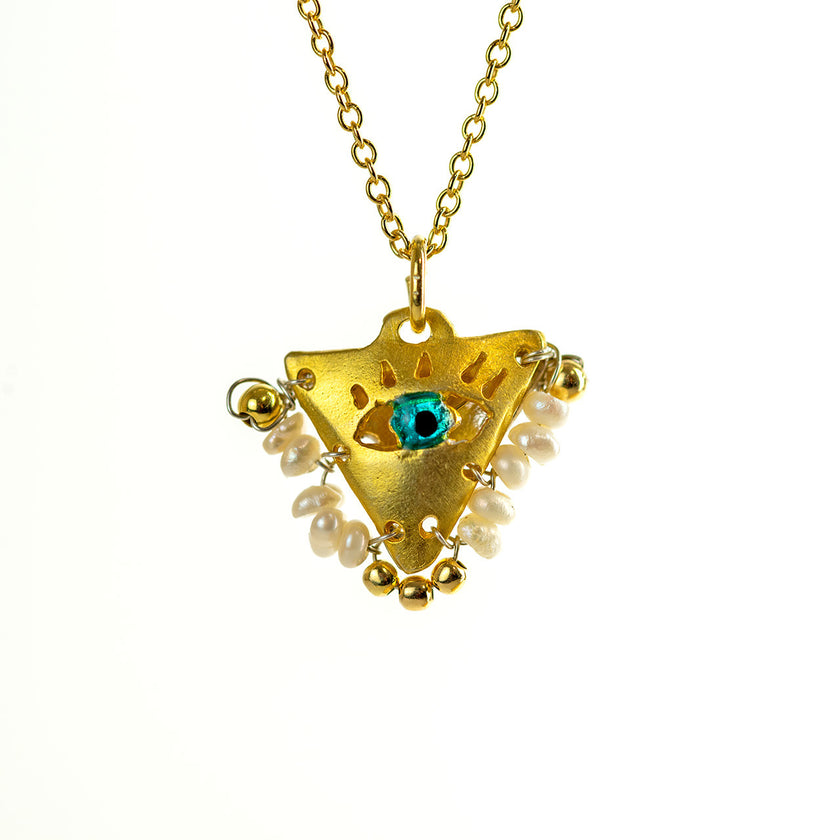 Close up of handcrafted pearl white filakto talisman charm necklace