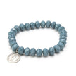 Close up of sparkly silver coin bracelet in mineral gray