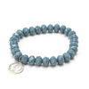 Close up of sparkly silver coin bracelet in mineral gray