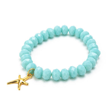 Close up of turquoise sparkly rocks & gold starfish bracelet