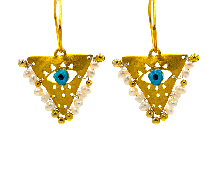 Gold-plated silver earrings with Pearl White beads and blue evil eye charm. Handcrafted jewelry inspired by the Filakto, a...