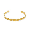 Slim gold tone stainless steel cuff bracelet with repeating textured curved pattern