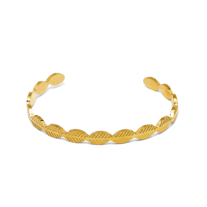 Slim gold tone stainless steel cuff bracelet with repeating textured curved pattern
