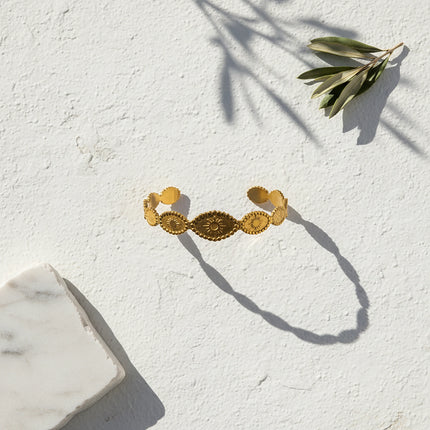 Close up of helia sun medallion cuff bracelet
