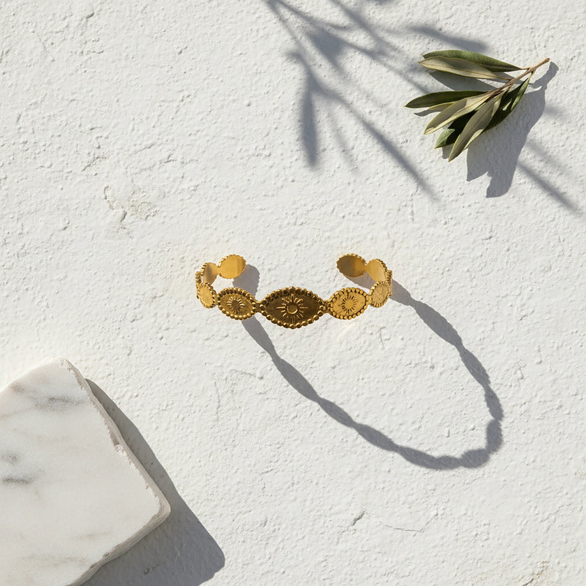 Close up of helia sun medallion cuff bracelet