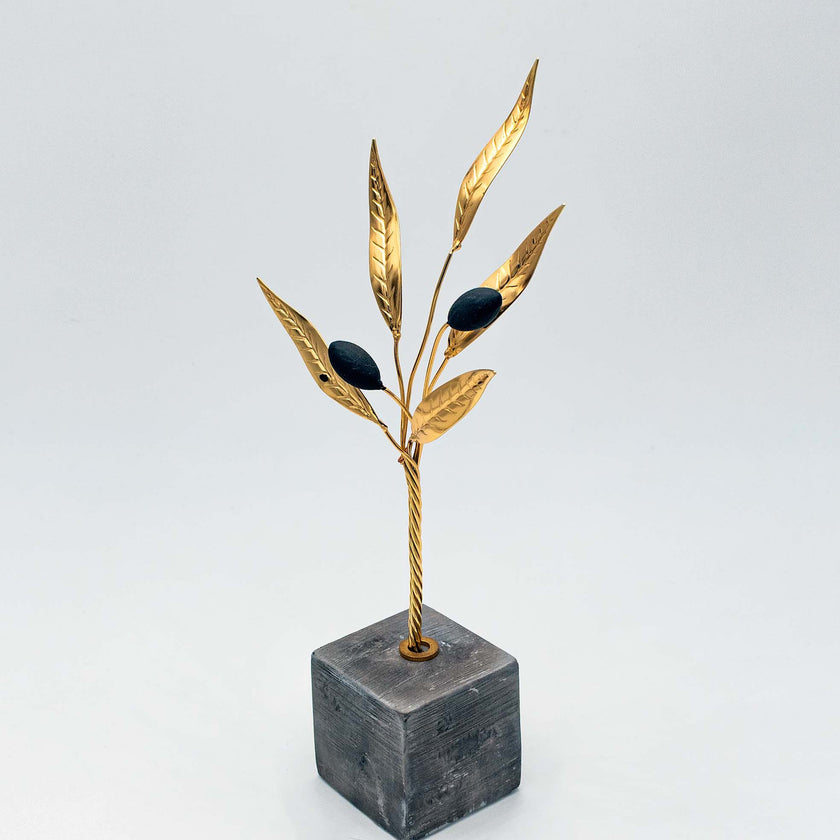Close up of golden olive branch in black, handcrafted
