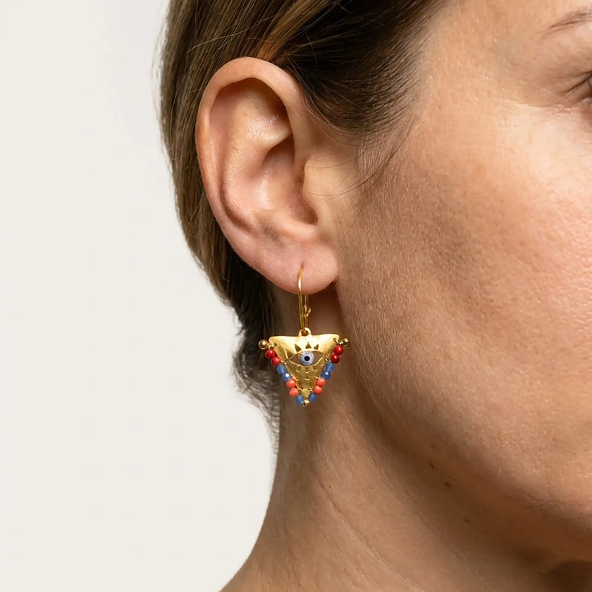 Close up of medium Sunset Reef fylachto earring in gold plated sterling silver with handpainted eye