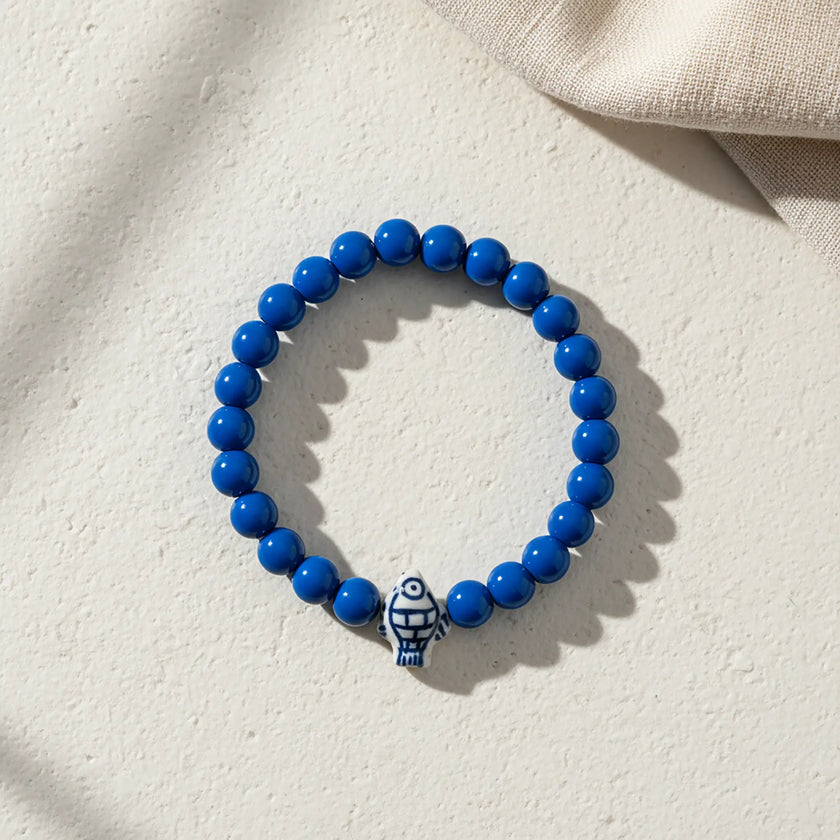 Handmade blue bead bracelet from Naxos with blue and white fish centerpiece