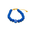 Adjustable bracelet with bright blue beads and classic blue evil eye centerpiece