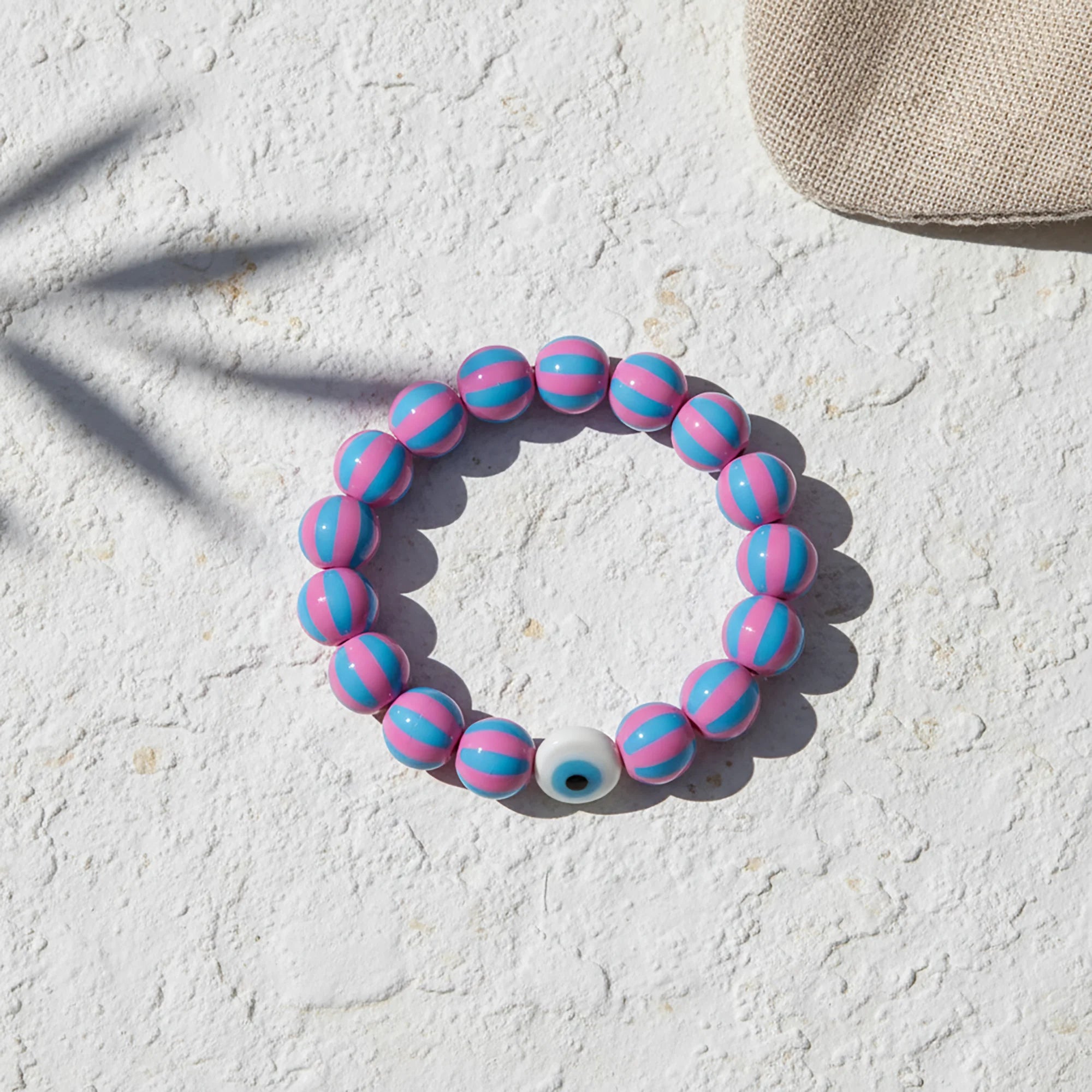 Handmade candy stripe evil eye bracelet from Naxos with pink and blue beads