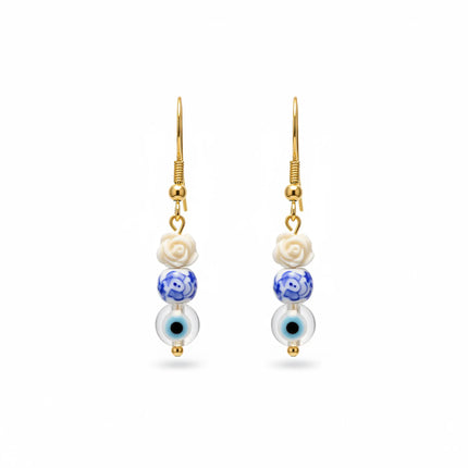 Handmade earrings from Naxos with white rose bead, blue patterned bead, and evil eye charm
