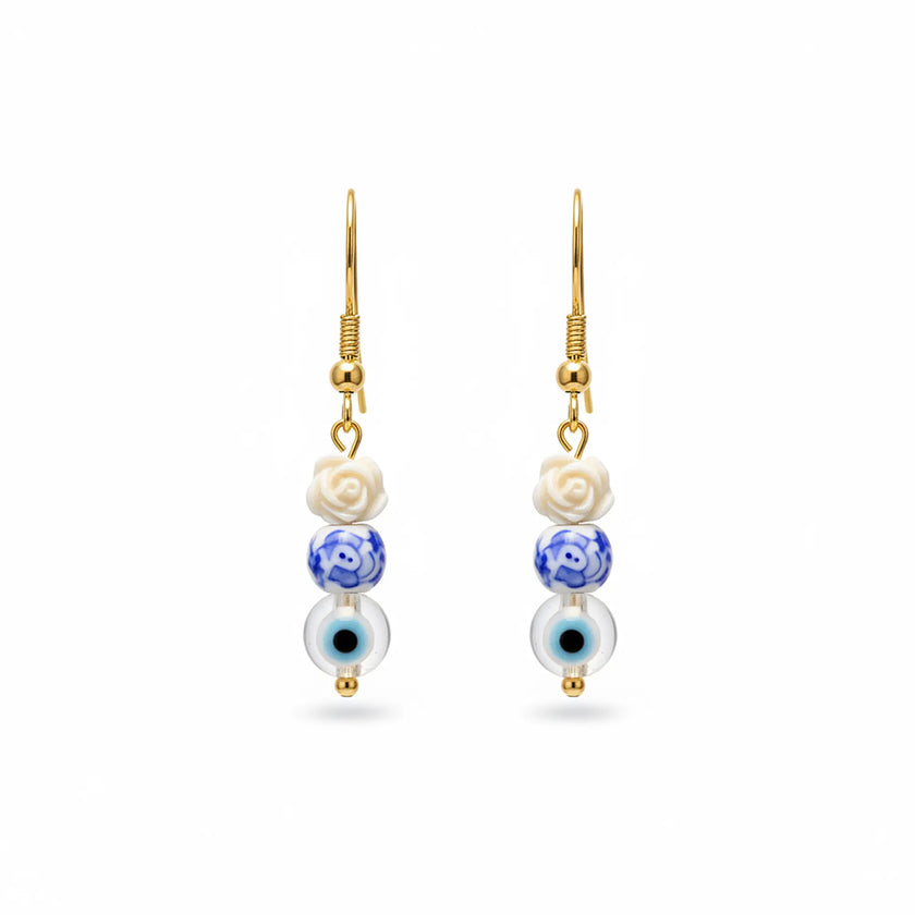 Handmade earrings from Naxos with white rose bead, blue patterned bead, and evil eye charm