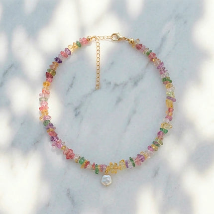 Drosia pastel stone necklace with freshwater pearl styled on marble