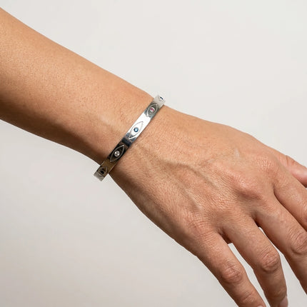 Close up of evil eye bangle bracelet