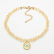 Ilios natural citrine necklace with sunburst evil eye pendant flat lay