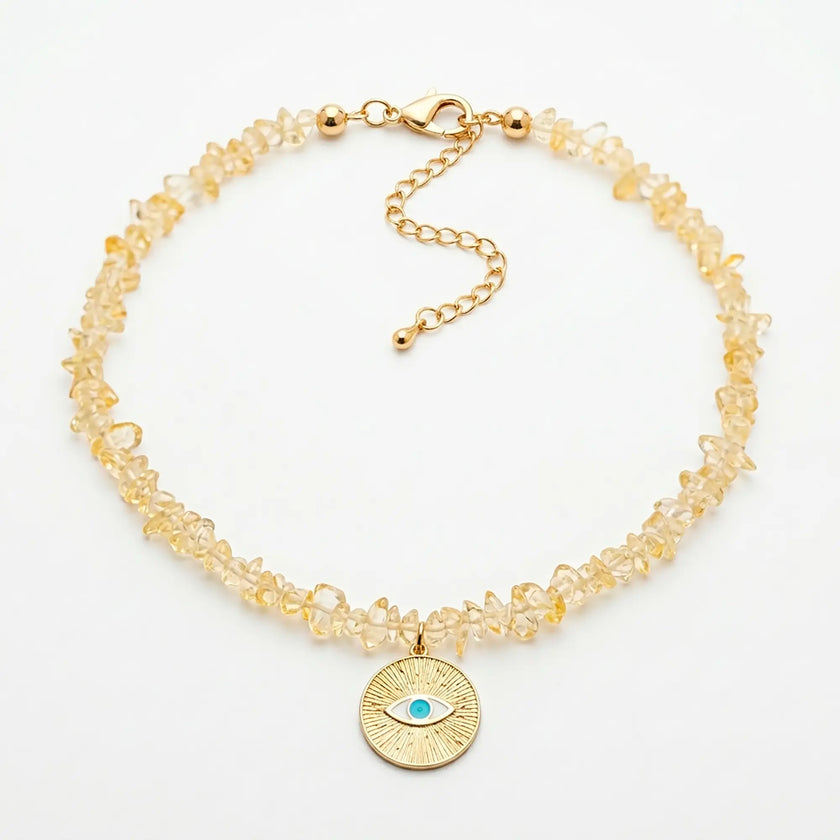 Ilios natural citrine necklace with sunburst evil eye pendant flat lay